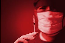 Wrong medication drug vaccine abuse silent dying danger kill patient lethal injection in hospital concept. Doctor holding syringe red color tone - stock photo