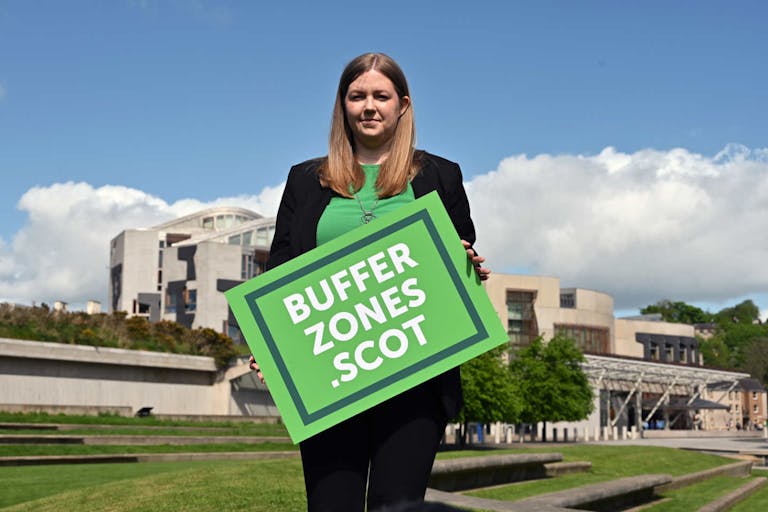 Photo: Ken Jack/Getty Images EDINBURGH, SCOTLAND - MAY 19: Scottish Green Party MSP Gillian Mackay holds a placard outside the Scottish Parliament in support of the creation of buffer zones around abortion clinics, where some clients have felt intimidated by protesters, on May 19, 2022 in Edinburgh, Scotland. Ms Mackay was launching a consultation on her legislative proposal to designate protest free 'buffer zones' outside abortion clinics across the country. (Photo by Ken Jack/Getty Images)
