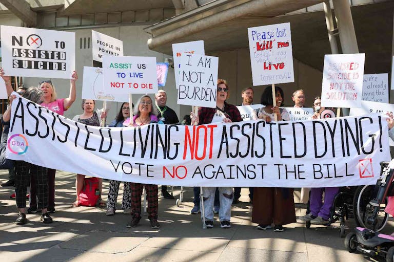 EDINBURGH, SCOTLAND - MAY 13: Opponents on the vote on the plans to legalise assisted dying demonstrate outside the Scottish Parliament to show support against Stage 1 of Scotland’s assisted dying bill on May 13, 2025 in Edinburgh, Scotland. MSPs are voting on whether or not to allow terminally ill adults to seek medical help to end their lives in the Scottish Parliament today.