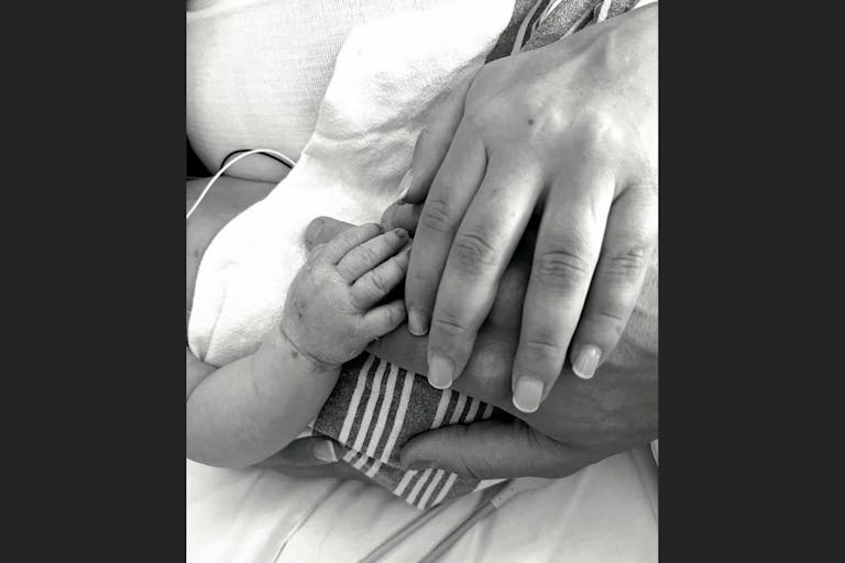 Screenshot: Alex Vesia Instagram Black-and-white image of a stillborn baby's hand with her parents' hands.