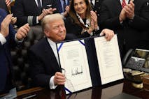 WASHINGTON, DC - NOVEMBER 12: U.S. President Donald Trump signs funding legislation to reopen the federal government as he is joined by Rep. Lisa McClain (R-MI), other Republican lawmakers and business leaders, during a ceremony in the Oval Office of the White House on November 12, 2025, in Washington, DC. The legislation, passed by the House of Representatives tonight, funds the federal government until the end of January 2026 and ends the 43-day government shutdown, the longest in the nation’s history.