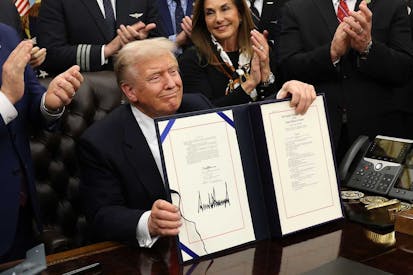 WASHINGTON, DC - NOVEMBER 12: U.S. President Donald Trump signs funding legislation to reopen the federal government as he is joined by Rep. Lisa McClain (R-MI), other Republican lawmakers and business leaders, during a ceremony in the Oval Office of the White House on November 12, 2025, in Washington, DC. The legislation, passed by the House of Representatives tonight, funds the federal government until the end of January 2026 and ends the 43-day government shutdown, the longest in the nation’s history.