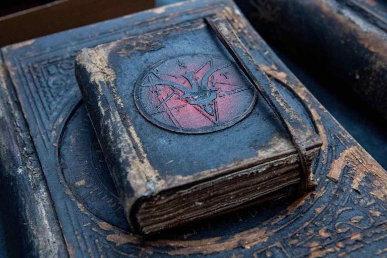 Photo: JOSEPH PREZIOSO/AFP via Getty Images The Satanic Temple's logo is on vintage-looking notebooks for ministers at Satan Con in Boston, Massachusetts, on April 28, 2023. - According to the temple's website the convention is calling itself the largest gathering of Satanic Temple members from around the world. The temple is celebrating its ten year anniversary, being founded in 2013. The group claims to not view the devil as an actual deity but as a fictional figure and is a recognized church by the Internal Revenue Service (IRS). (Photo by Joseph Prezioso / AFP)
