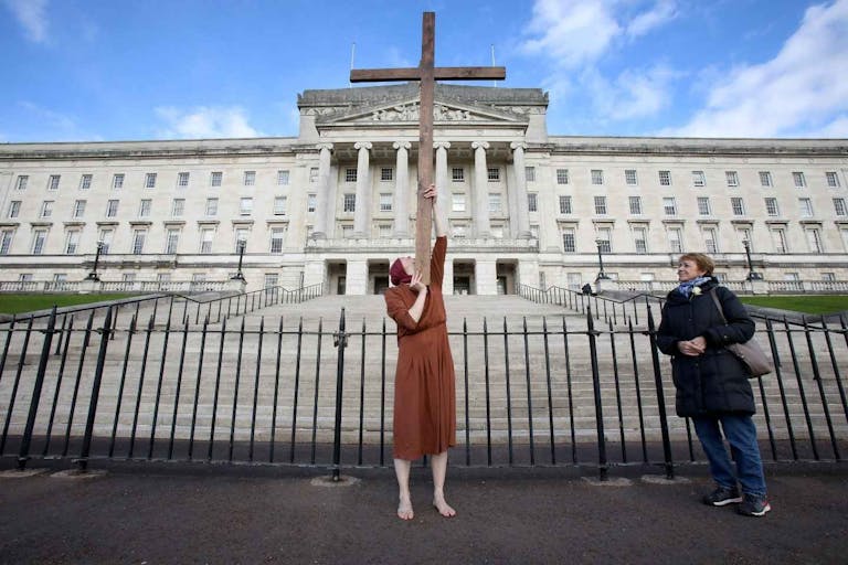 An anti-abortion activist poses for a photograph whilst demonstrating outside of Parliament Buildings, the seat of the Northern Ireland Assembly, on the Stormont Estate in Belfast, Northern Ireland, on October 21, 2019, as a number of lawmakers returned to attend a special sitting. - A group of Northern Irish lawmakers returned to their parliament on Monday in a last-minute protest at the liberalisation of abortion laws, set to come into force after being decided by London for the suspended Belfast executive. The regional government in Belfast collapsed in January 2017 after a scandal over a renewable heating scheme split the power-sharing executive, amid a breakdown in trust. Abortion is currently illegal in the province, except when the mother's life is in danger.