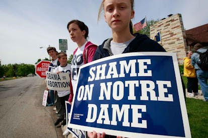 SOUTH BEND, IN - MAY 17: Anti-abortion activists from Virginia demonstrate near the campus of Notre Dame University on May 17, 2009 in South Bend, Indiana. Activists from around the country have gathered in South Bend to protest the university's decision to invite President Barack Obama, who supports abortion rights, to deliver the commencement address today and to award him an honorary degree.