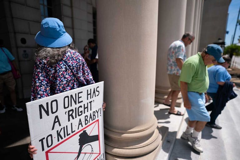 Photo: Sean Rayford/SOPA Images/LightRocket via Getty Images COLUMBIA, SOUTH CAROLINA, UNITED STATES - 2023/06/24: Anti-abortion demonstrators pray outside the South Carolina Supreme Court in anticipation of next week's hearings on a recently passed abortion law. The Court will begin hearing arguments challenging the state's recently passed six-week abortion ban on June 27 - after striking down the state's previous law in January.