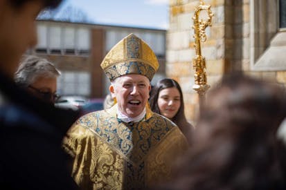 TOLEDO, OHIO, UNITED STATES - 2022/04/17: Reverend Daniel E. Thomas, 8th Bishop of the Diocese of Toledo, greets people as they leave after the Easter morning mass. On Sunday, people gather to attend the Easter Sunday morning mass hosted by Our Queen of the Most Holy Rosary Cathedral.
