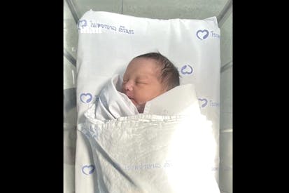 Screenshot: The Daily Mail newborn baby girl abandoned in toilet tank in Bangkok, Thailand, lays in bassinet