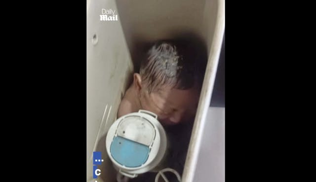 Screenshot: Baby girl in toilet tank in Thailand (The Daily Mail) baby girl shown stuffed inside toilet tank in Bangkok, Thailand