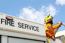 BUNGENDORE, AUSTRALIA - JANUARY 09: A ACT Rural Fire Service member watches water-bombing operations take place on a fire at Sandhills on January 9, 2013 in Bungendore, Australia. Temperatures cooled overnight offering relief to fire fighters following yesterday's heat wave recording temperatures of over 40-plus degrees across the state. Crews continue to fight blazes today, taking advantage of the improved conditions ahead fire danger conditions predicted later in the week.