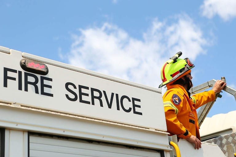 BUNGENDORE, AUSTRALIA - JANUARY 09: A ACT Rural Fire Service member watches water-bombing operations take place on a fire at Sandhills on January 9, 2013 in Bungendore, Australia. Temperatures cooled overnight offering relief to fire fighters following yesterday's heat wave recording temperatures of over 40-plus degrees across the state. Crews continue to fight blazes today, taking advantage of the improved conditions ahead fire danger conditions predicted later in the week.