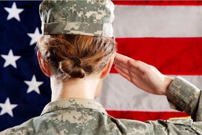Female American soldier standing & saluting. emale American Soldier Series: Saluting - stock photo