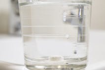 Photo: Aitor Diago/Getty Images Glass of water with a pill inside it.