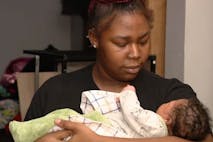 Photo: Traci Fant/Facebook Photo shows a Black teenaged girl looking into the face of her newborn baby boy.