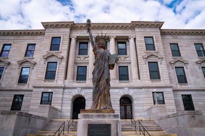 Missouri Green County Courthouse Building with the Statue of Liberty at the Entrance in the City of Springfield: A small town American Heartland historic tourist attraction - stock photo