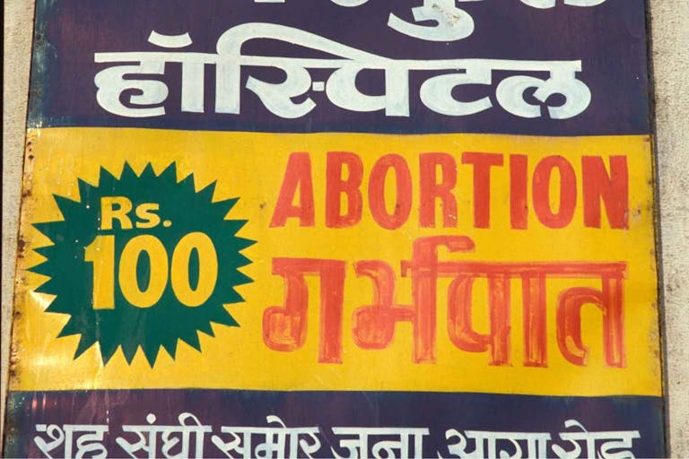 Photo: BSIP/Universal Images Group via Getty Images India, Advertisement for abortions. India.