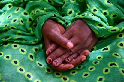 FILED - 29 May 2019, Libya, Niamey: An escaped woman puts her hands in her lap. The UNHCR had evacuated numerous refugees from politically unstable Libya to bring them to safety in Niger. They were rescued from the worst conditions in Libya and brought to Niger with the promise of being resettled in Europe. But many migrants there would have to stay in Limbo for months or even years before they could ever set foot on European soil. (to dpa "Saved from Libya, stranded in Niger: Refugees hope for Eldorado Europe") Photo: Esma Cakir/dpa (Photo by )