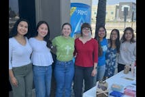 Pro-life students gather at a table with dipaer dontaions for moms in need.