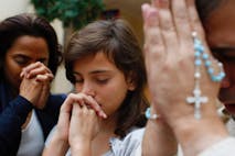 Photo: Getty Images Family praying at home - stock photo