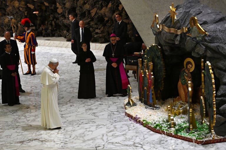 Pope Leo XIV stands in front of a Christmas crib during an audience to Donors of the nativity scene and christmas tree, at Paul-VI hall in The Vatican on December 15, 2025.
