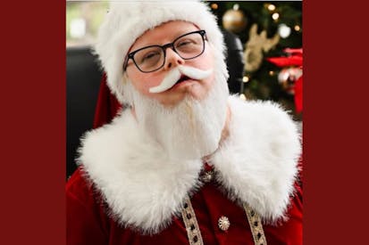 Bradley Carlisle dressed in a red Santa suit.
