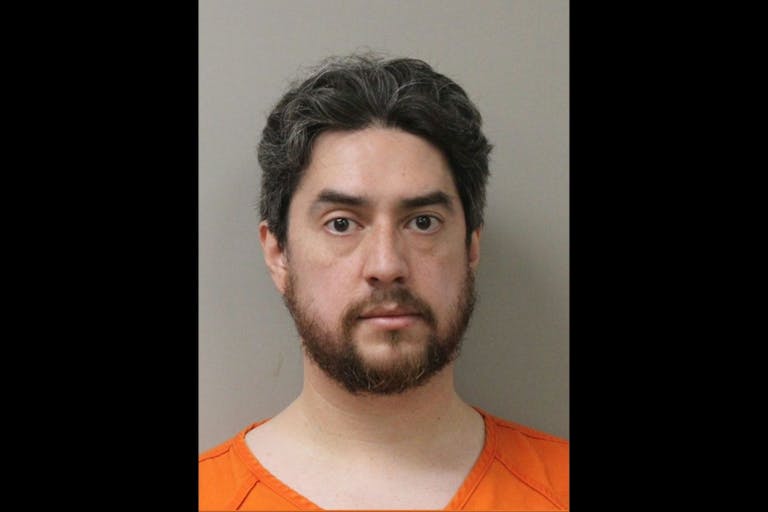 Photo: City of LaCrosse, Wisconsin Image shows a bearded man in an orange jumpsuit posing for a mugshot.