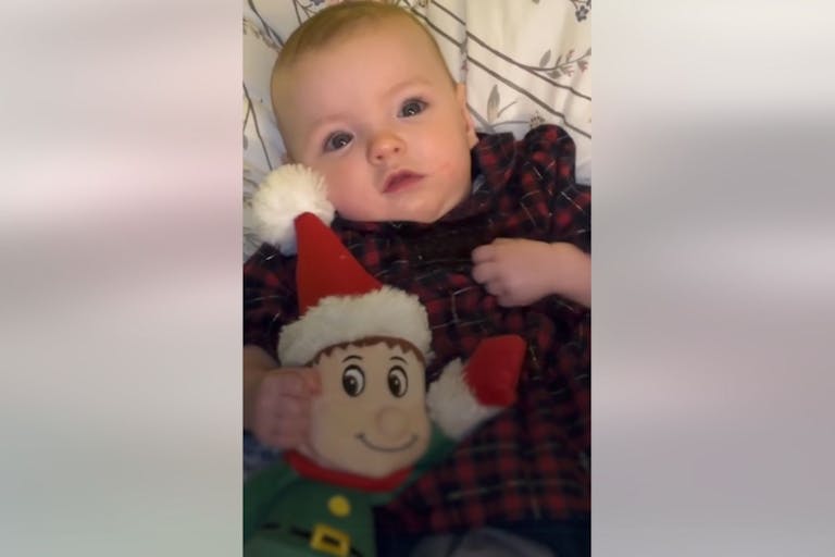 Photo: Belfast Live Image shows baby girl holding a stuffed elf for Christmas.