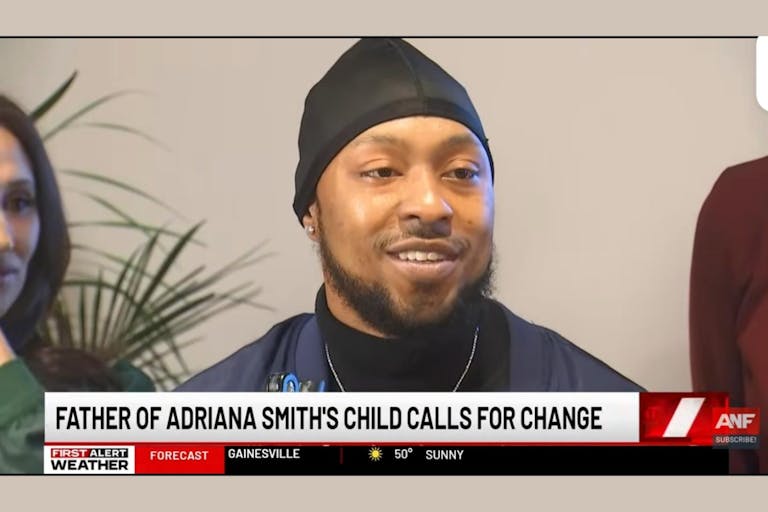 Image shows Adrian Harden smiling as he speaks to the press about his son, Chance.