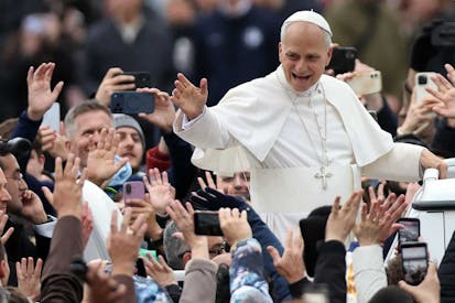VATICAN, ITALY - 2025/12/25: The Pope toured St. Peter's Square in the Popemobile to greet thousands of faithful gathered in the square in the rain after celebrating his first Christmas Mass at the central altar of St. Peter's Basilica. Pope Leo XIV presided over his first Christmas Mass at the central altar of St. Peter's Basilica in the Vatican, during the solemn celebration that opens Christmas for the Catholic Church, reminding the faithful of the message of peace, hope, and the birth of Jesus. (Photo by Marco Iacobucci/SOPA Images/LightRocket via Getty Images)