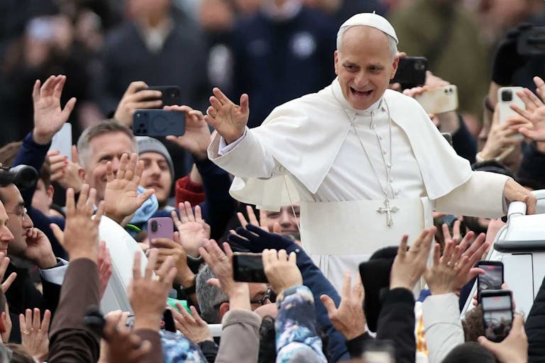 VATICAN, ITALY - 2025/12/25: The Pope toured St. Peter's Square in the Popemobile to greet thousands of faithful gathered in the square in the rain after celebrating his first Christmas Mass at the central altar of St. Peter's Basilica. Pope Leo XIV presided over his first Christmas Mass at the central altar of St. Peter's Basilica in the Vatican, during the solemn celebration that opens Christmas for the Catholic Church, reminding the faithful of the message of peace, hope, and the birth of Jesus. (Photo by Marco Iacobucci/SOPA Images/LightRocket via Getty Images)