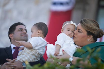 Governor-elect Jenniffer Gonzalez and her husband, Jose Yovin Vargas hold their babies during her swearing in ceremony at the Capitol building in San Juan, Puerto Rico on January 2, 2025. (Photo by Ricardo ARDUENGO / AFP) (Photo by RICARDO ARDUENGO/AFP via Getty Images)