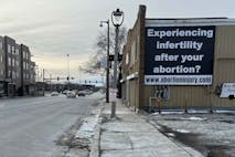 Image shows billboard stating, “Experiencing Infertility after Your Abortion?”