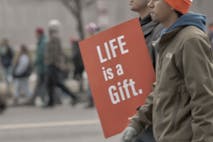 Screenshot: March for Life 2026 March for Life participants carry a sign saying "Life is a gift."