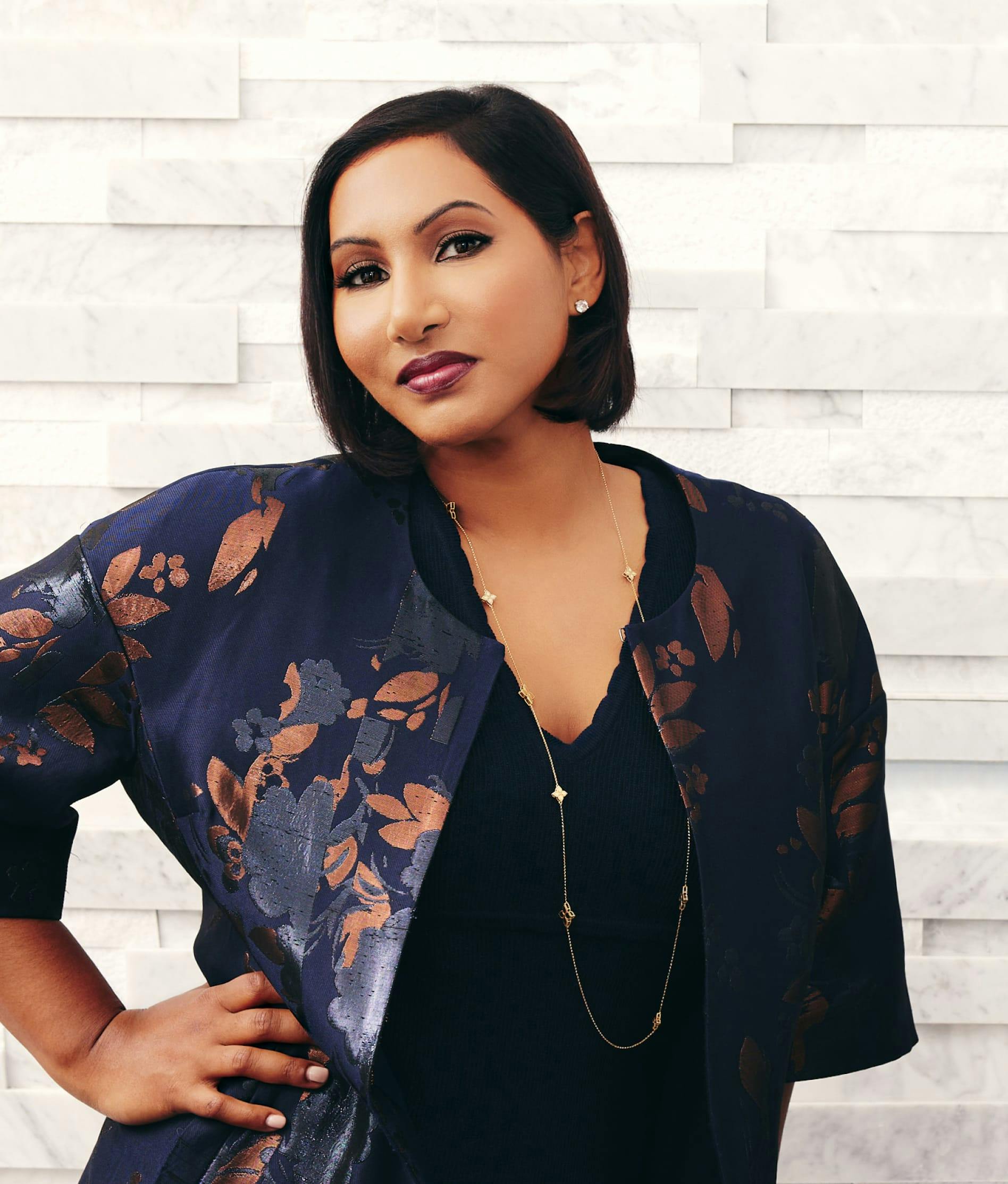 Dr. Anu Antony in front of a wall