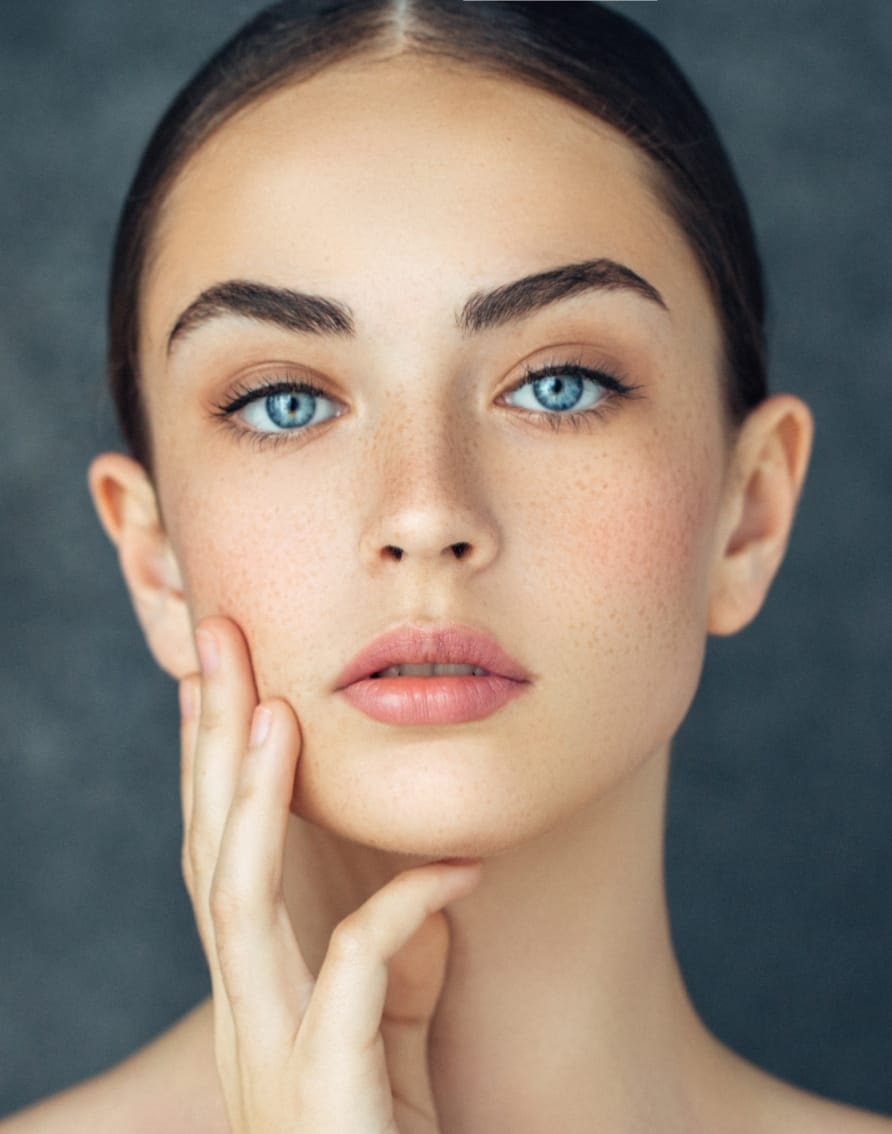 Woman touching face after rf microneedling