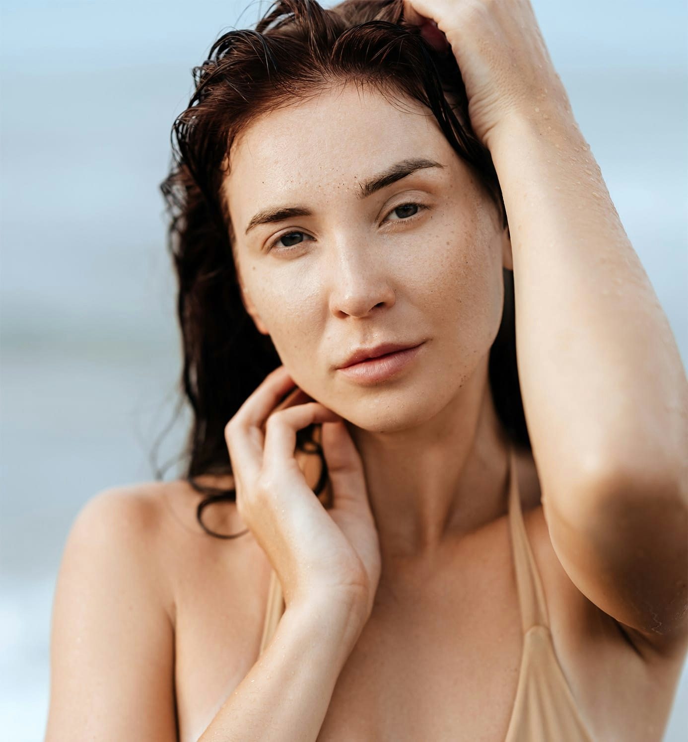 woman with wet hair with hands on neck and head