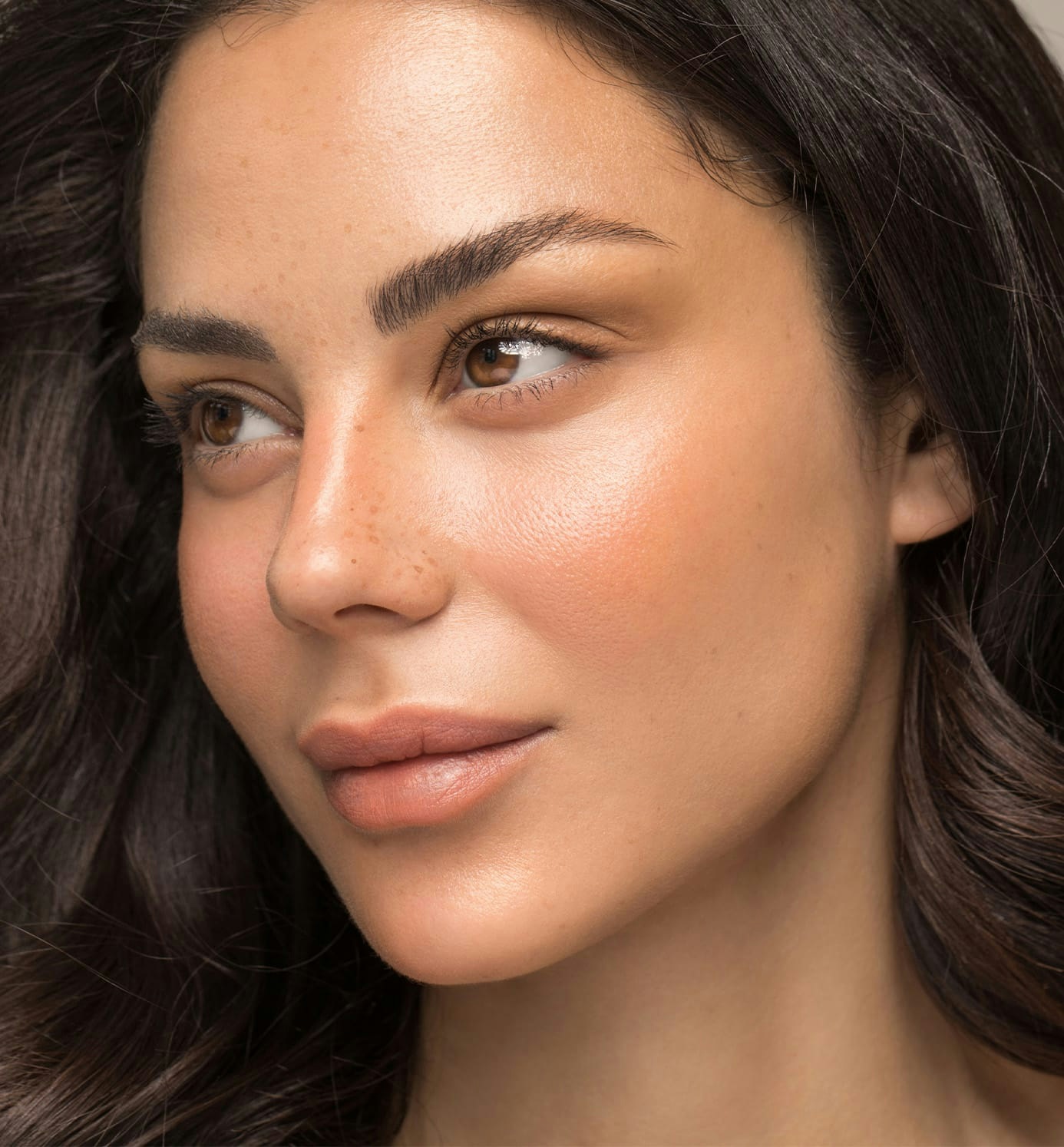 close up of woman with brown hair looking to the left