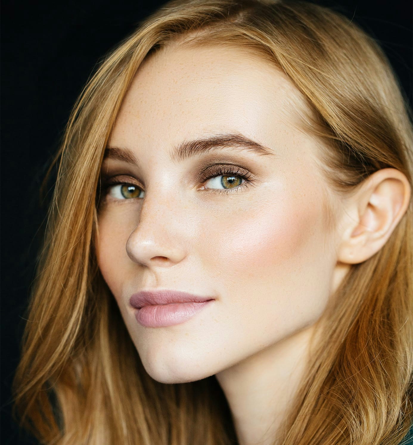 woman with ginger hair looking forward while facing to the left