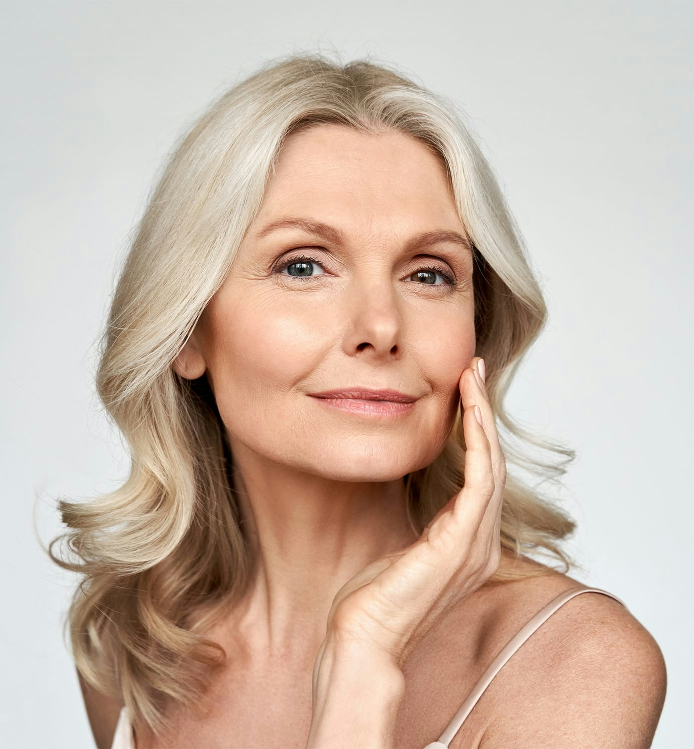 older woman with hand on her cheek