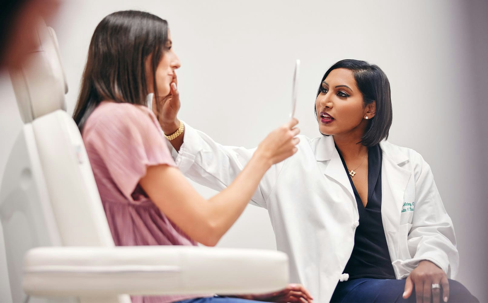 doctor with patient sitting in chair