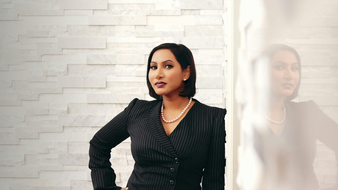 Dr. Anu Antony leaning against wall