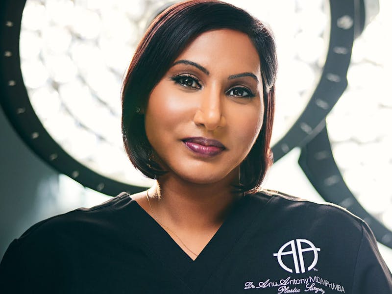 doctor in scrubs with light behind