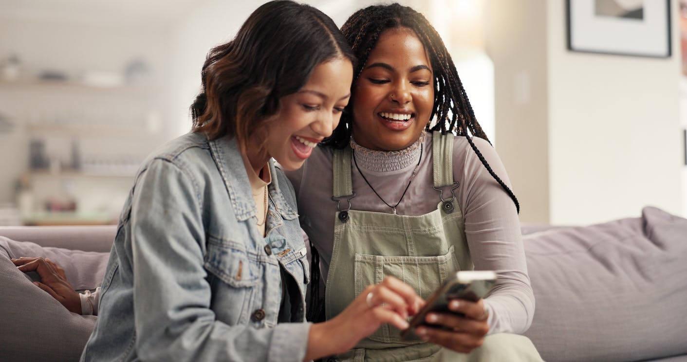two friends looking at a phone