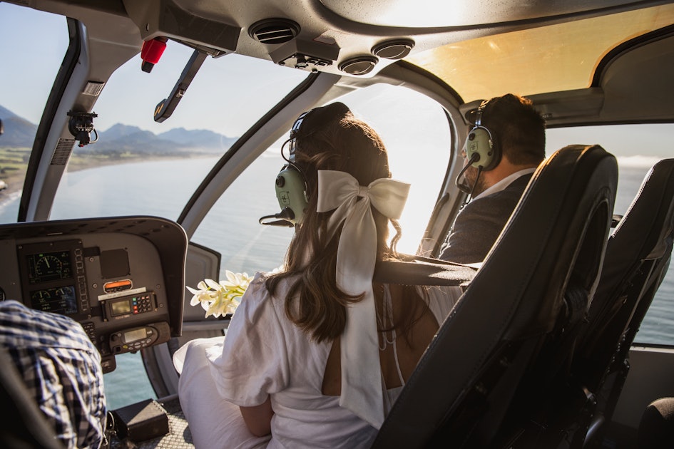 Bride and groom in a helicopter overlooking Mangamaunu