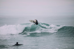 Surfer catching wave in Kaikoura