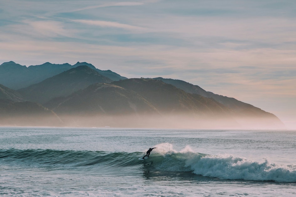 Surfer catches a wave in Kaikoura