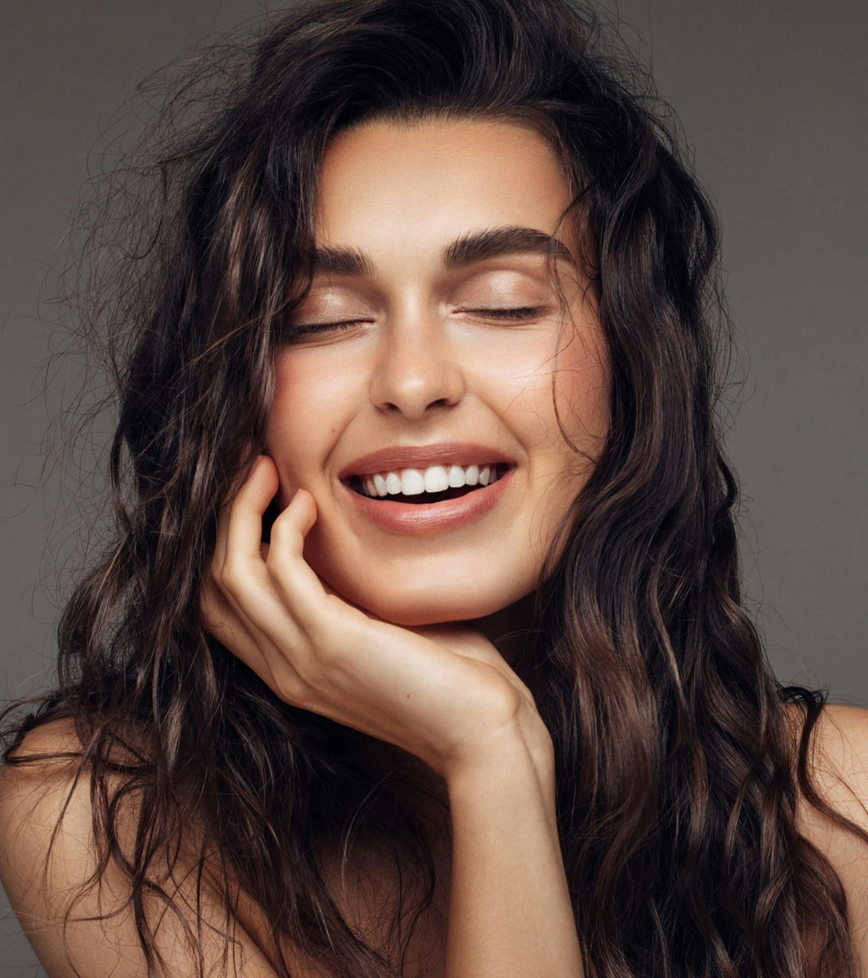 woman resting her face in her hand