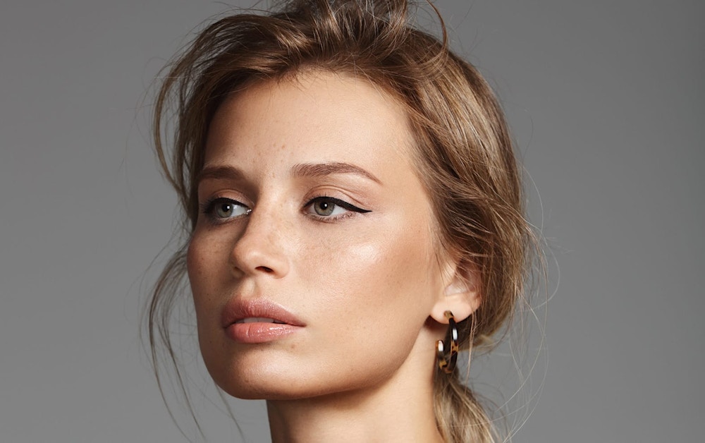 woman with blonde hair looking left