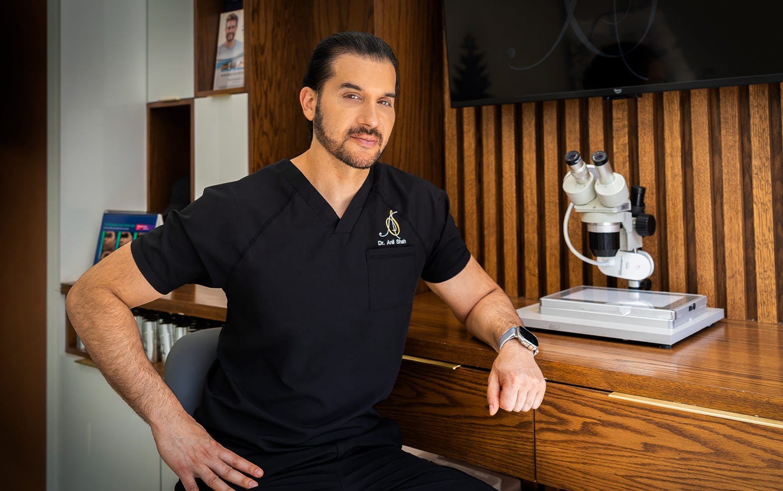 Dr. Shah leaning against a counter
