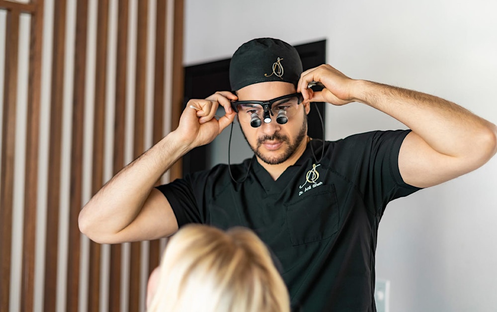 Dr. Shah putting on glasses